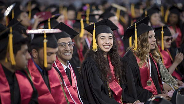 Students smiling at commencement. 