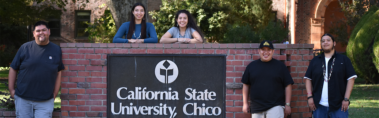Students standing by the California State University Chico sign