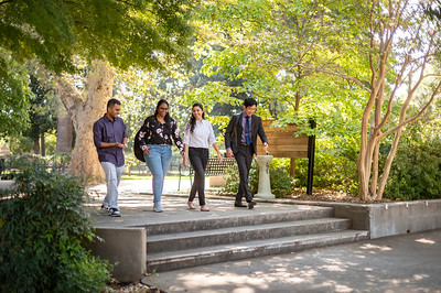 Students walking on campus alongside Kendall Hall