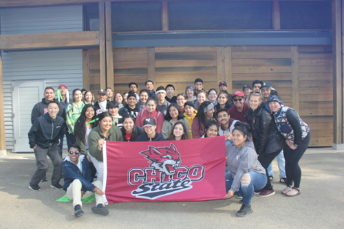 TRIO SSS students and staff pose with a Chico State flag.
