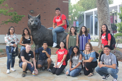 TRIO students posing next to the campus' Wildcat statue.