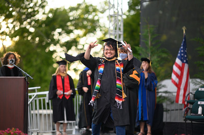 Graduate student walking across the graduation stage.