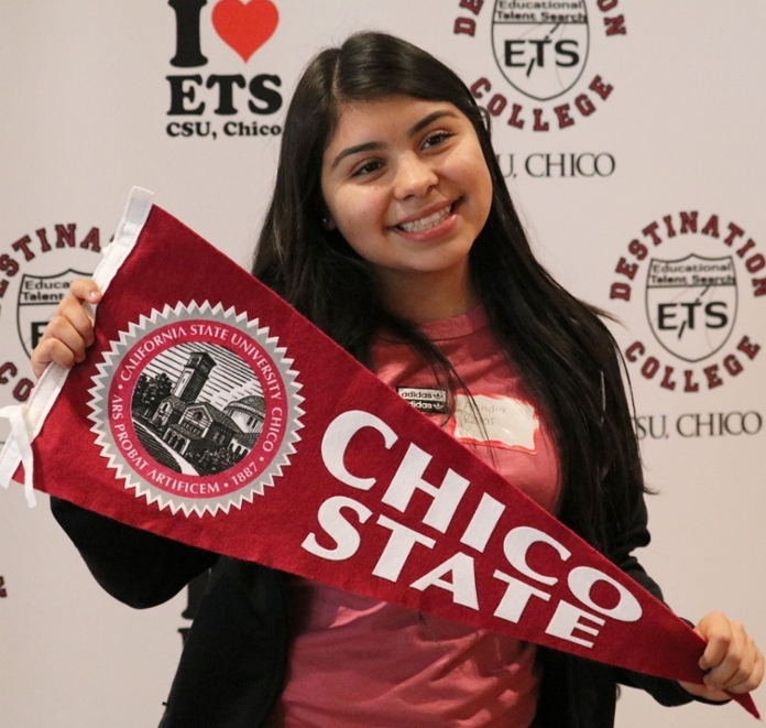 Student posing with a California State University, Chico pendant flag