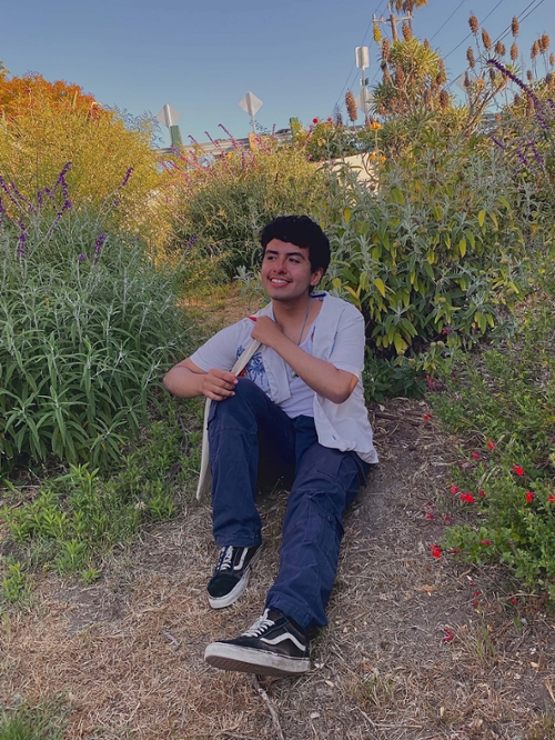 jose smiling and sitting on the ground