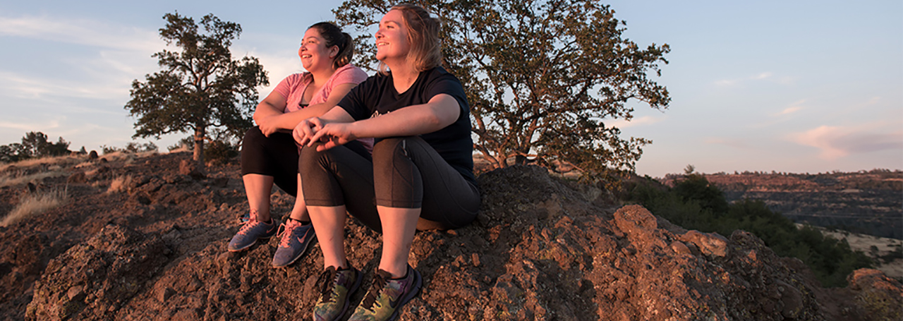 Two students enjoy sunset from Upper Bidwell Park