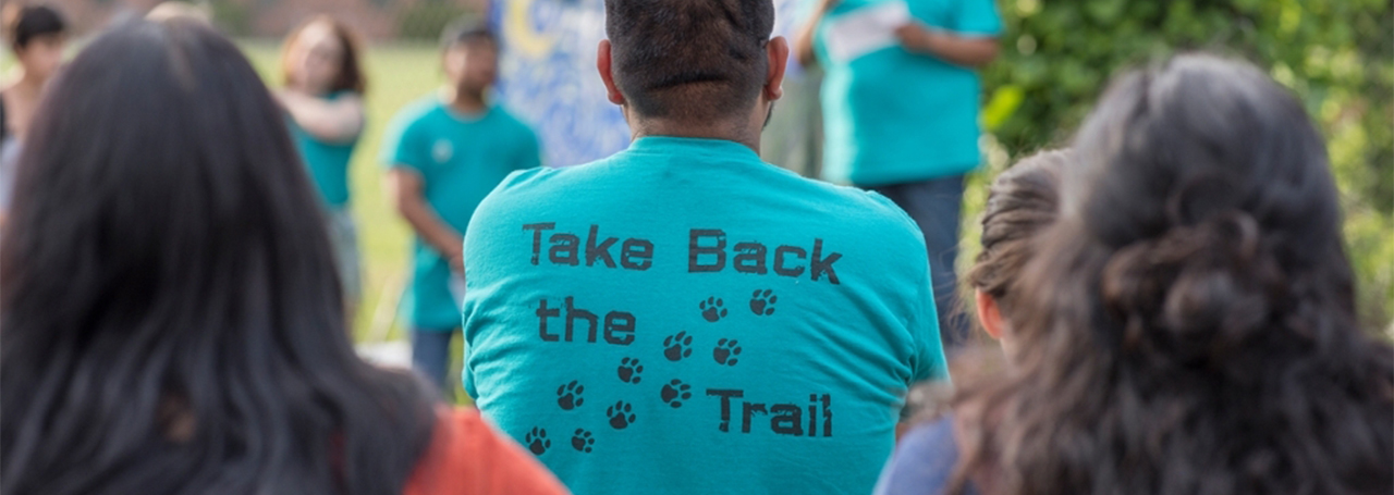A student wears a "Take back the Trail" shirt, referring to the bike path 