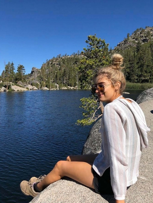 sabrina smiling in front of a lake