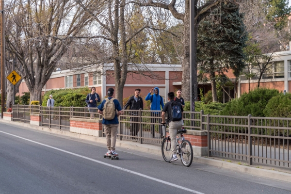 Students ride bikes and skateboards