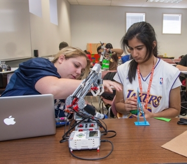 two students working on a robot