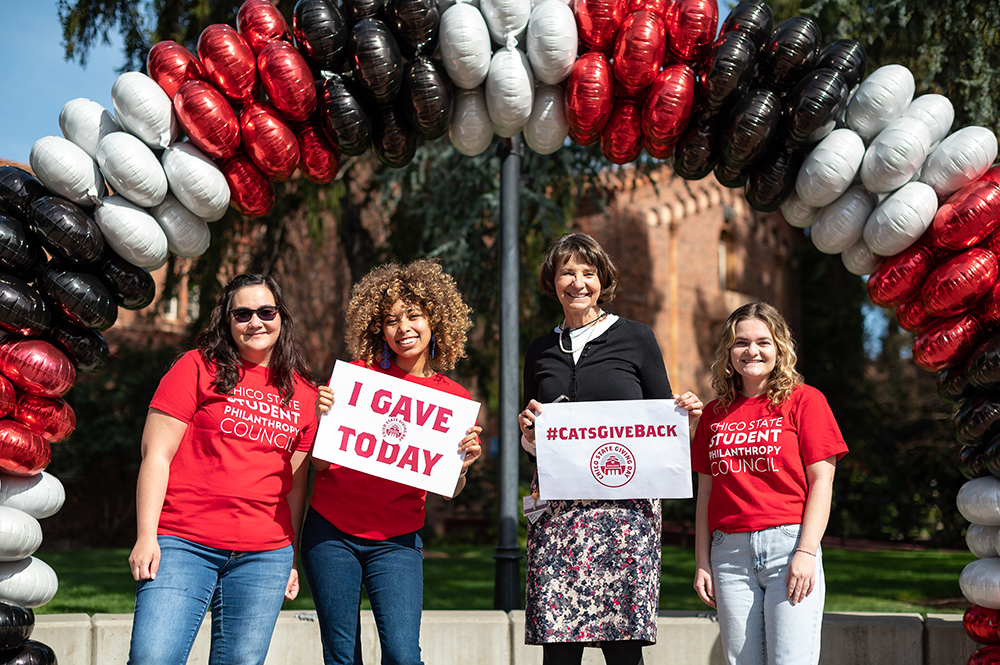 Provost Debra Larson poses with students at 2022's Giving Day