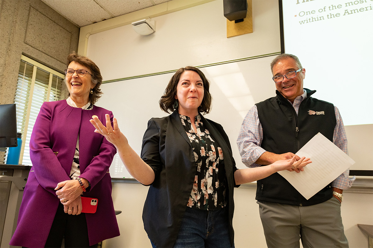 Interim Provost Steve Perez surprises Amy Magnus with the Outstanding Early Career Faculty Award