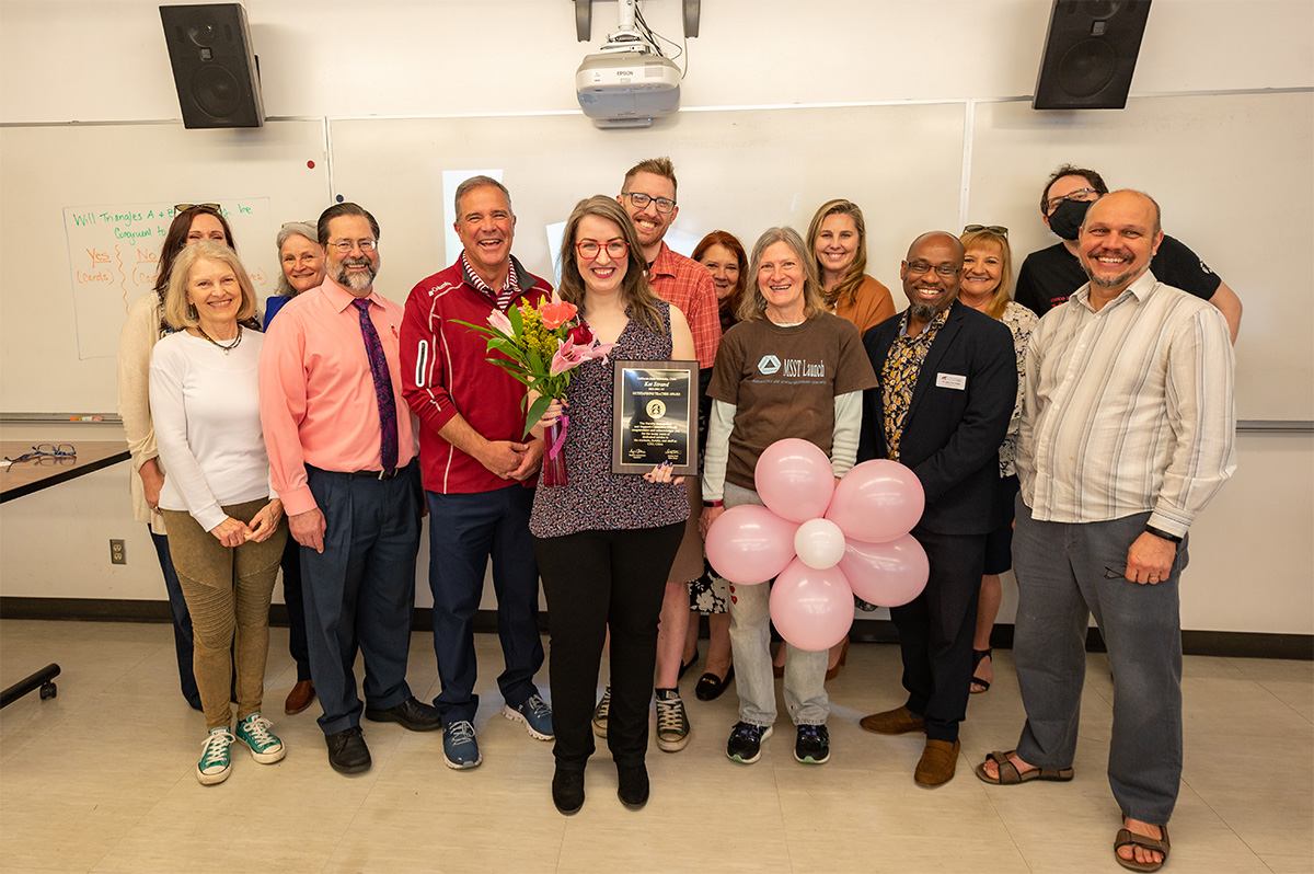 Interim Provost Steve Perez surprises Kat Strand with the Outstanding Teacher Award