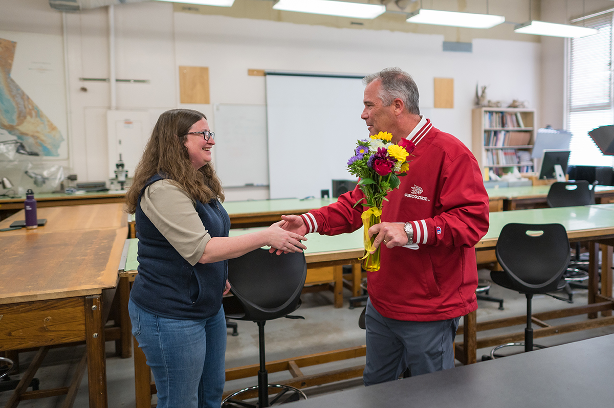 Interim Provost Steve Perez surprises Carly Whelan with the Outstanding Research Mentor Award