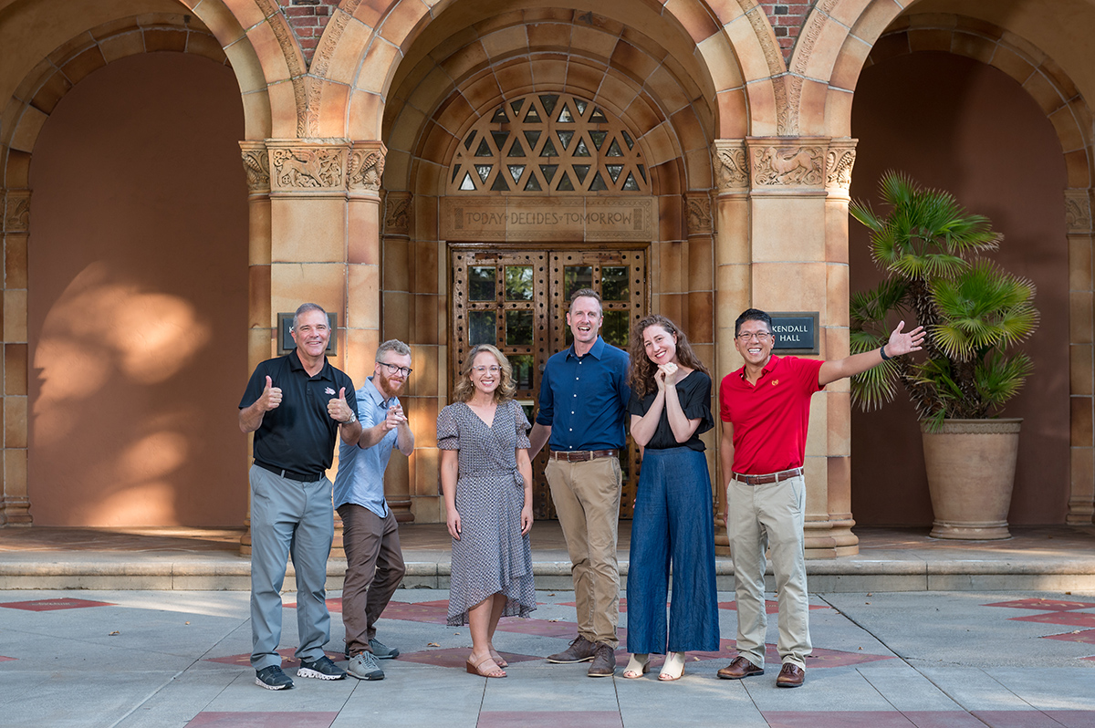 Interim Provost Lau poses with President Steve Perez and 2023's new faculty