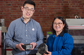Professors Ken Zhang and Jinsong Zhang show off concrete samples