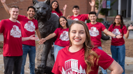 Students stand around the Wildcat Statue in front of the BMU