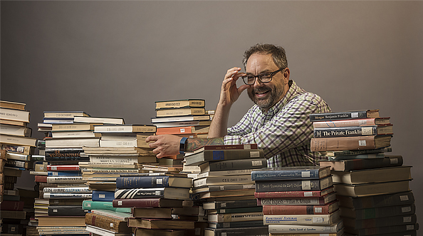 Librarian poses with books