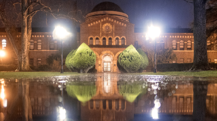 A shot of Kendall Hall at night as it rains
